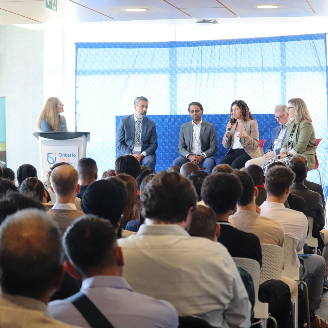 Image of a group of people listening to a panel. 